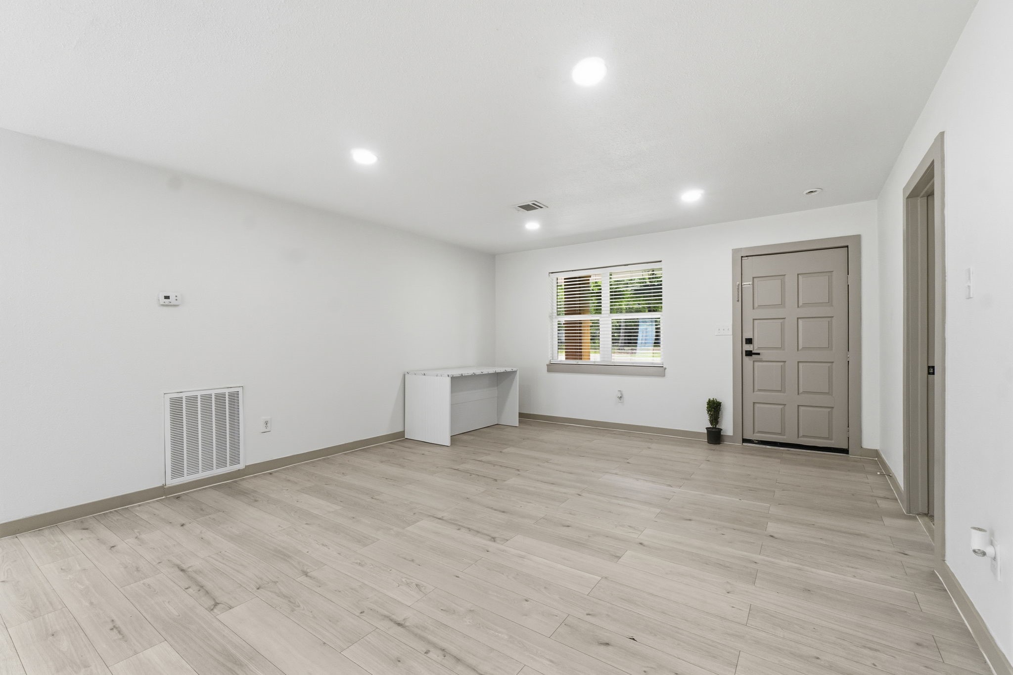 14850 Coaltown Road Willis, TX 77378 - Photo 5 of 41 Spacious living area filled with natural light featuring an open layout, contemporary flooring, and plenty of room for relaxing or entertaining.