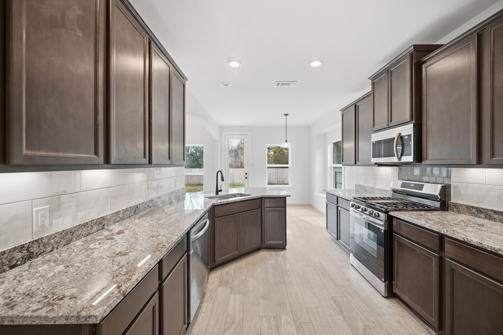 16507 Boston Post Road Cypress, TX 77429 - Photo 14 of 39 he kitchen is equipped with modern stainless steel appliances, combining style and functionality.