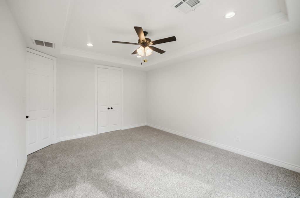 16507 Boston Post Road Cypress, TX 77429 - Photo 18 of 39 The primary bedroom features plush carpeting, recessed lighting, and an elegant tray ceiling.
