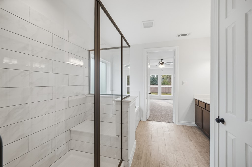 16507 Boston Post Road Cypress, TX 77429 - Photo 20 of 39 This alternate perspective showcases the primary en suite opening into the primary bedroom.