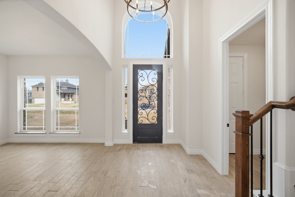 16507 Boston Post Road Cypress, TX 77429 - Photo 2 of 39 The home’s beautifully crafted wood and glass entry door, featuring decorative ironwork, welcomes you into the entryway with tile flooring and soaring ceilings.