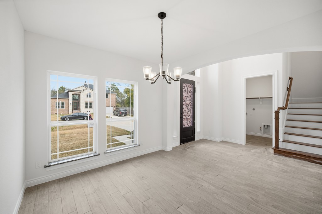 16507 Boston Post Road Cypress, TX 77429 - Photo 5 of 39 An alternate perspective showcases the seamless transition from the front entry, through the utility room, and into the dining room.