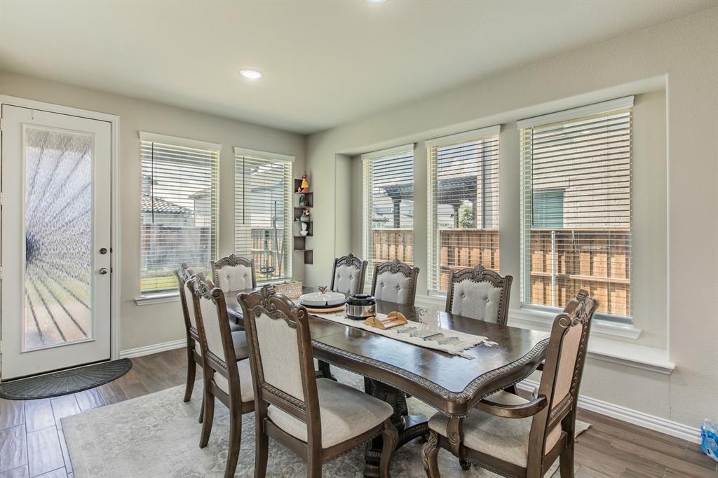 2521 Maidenhair Road Frisco, TX 75033 - Photo 7 of 39 Dining area featuring wood-finish flooring, recessed lighting, and a window wall with horizontal blinds