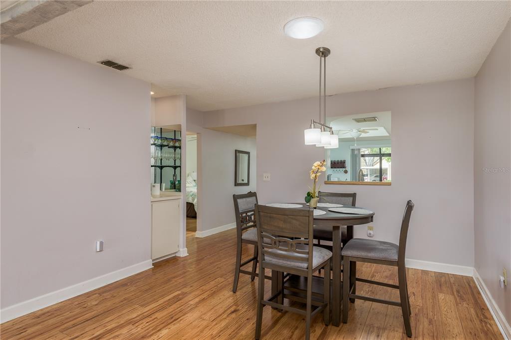11241 Dollar Lake Drive, Unit 5 Port Richey, FL 34668 - Photo 11 of 49 a view of a dining room with furniture window and wooden floor