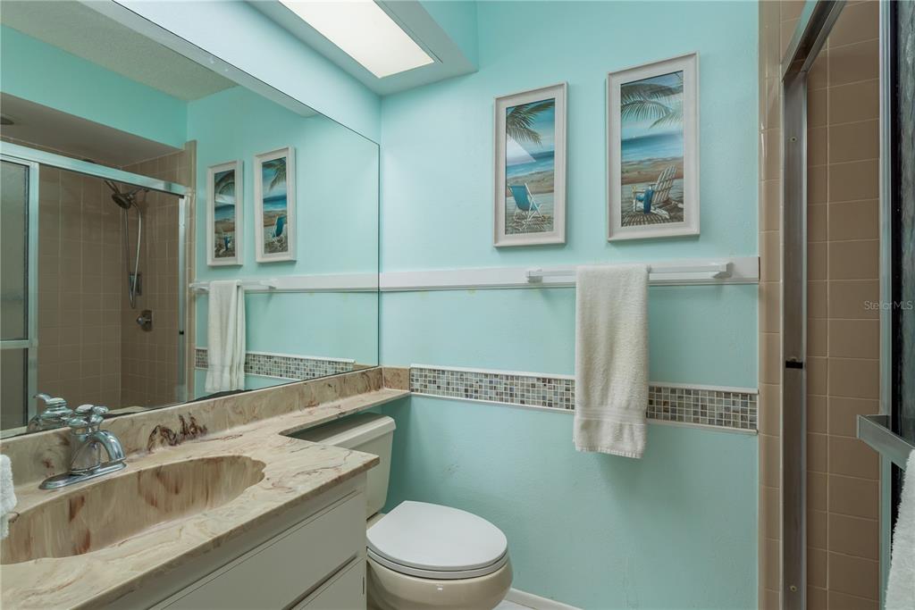 11241 Dollar Lake Drive, Unit 5 Port Richey, FL 34668 - Photo 19 of 49 a bathroom with a granite countertop toilet sink and mirror