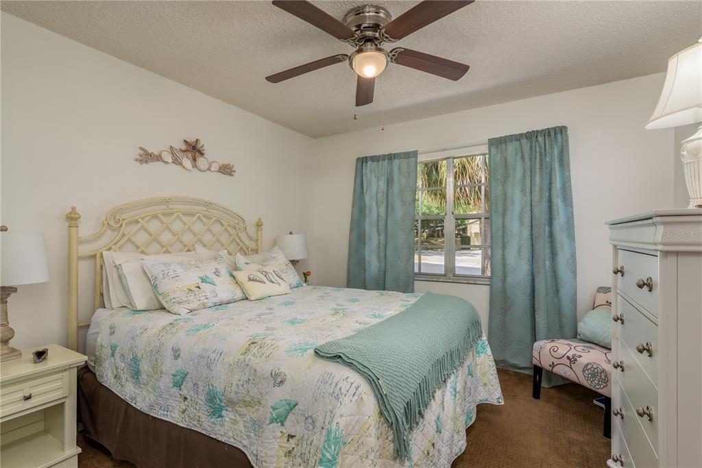 11241 Dollar Lake Drive, Unit 5 Port Richey, FL 34668 - Photo 20 of 49 a bedroom with a bed and a window