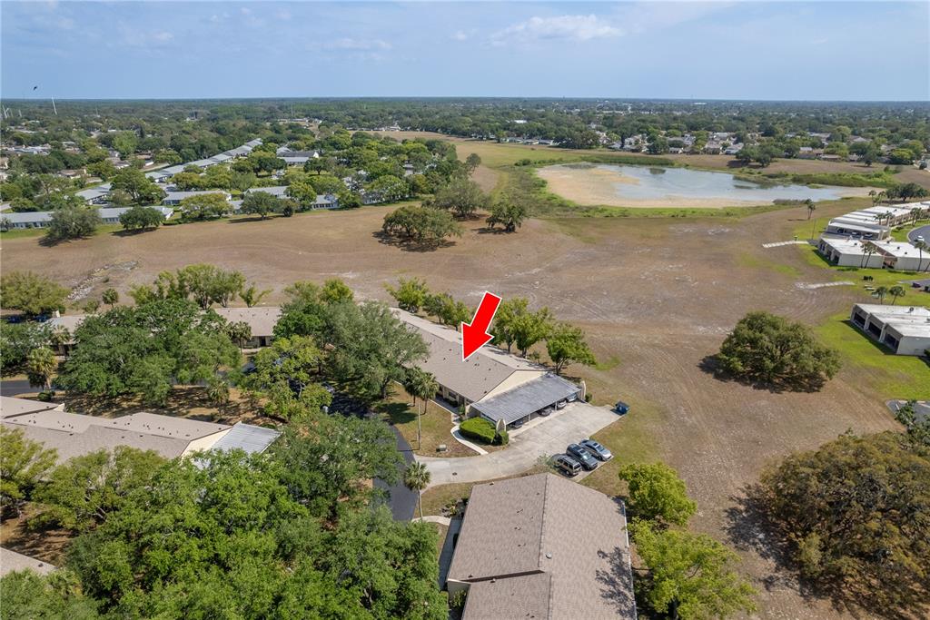 11241 Dollar Lake Drive, Unit 5 Port Richey, FL 34668 - Photo 2 of 49 an aerial view of a city with lots of residential buildings ocean and mountain view in back
