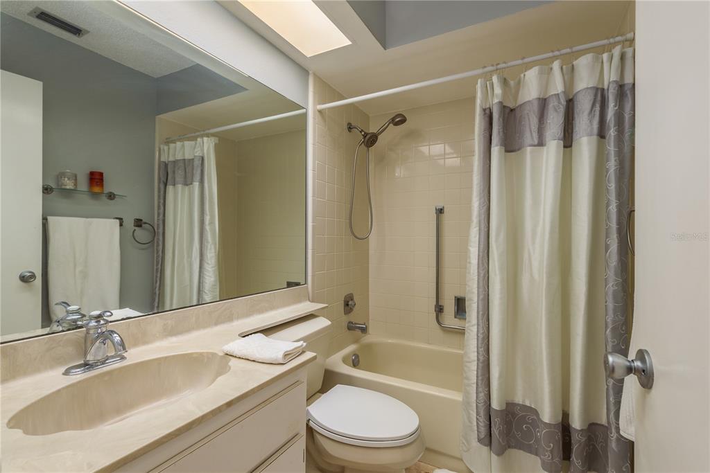 11241 Dollar Lake Drive, Unit 5 Port Richey, FL 34668 - Photo 22 of 49 a bathroom with a sink toilet and shower