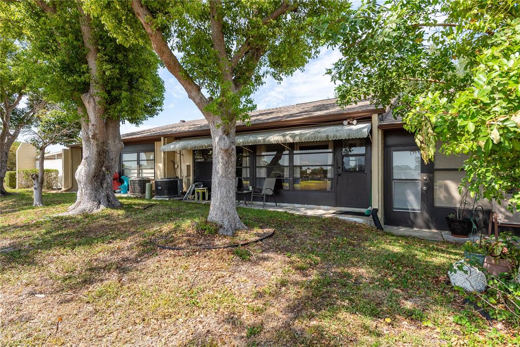 11241 Dollar Lake Drive, Unit 5 Port Richey, FL 34668 - Photo 27 of 49 a view of a house with yard and a tree
