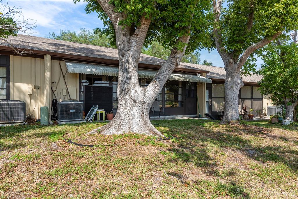 11241 Dollar Lake Drive, Unit 5 Port Richey, FL 34668 - Photo 28 of 49 a front view of a house with garden