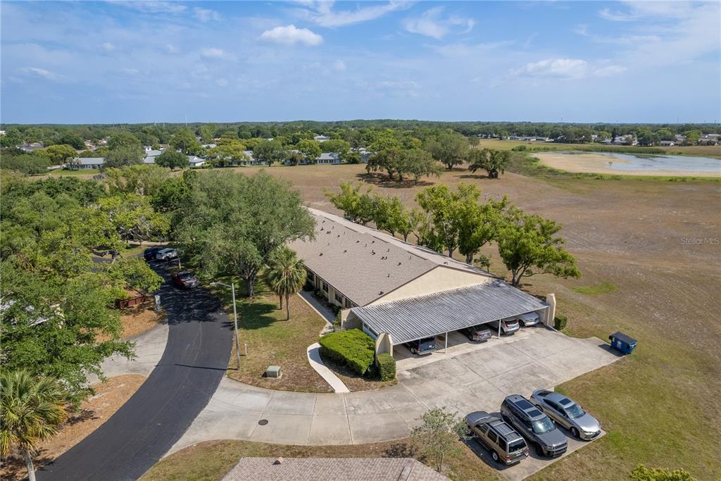 11241 Dollar Lake Drive, Unit 5 Port Richey, FL 34668 - Photo 30 of 49 an aerial view of a house with a yard and lake view