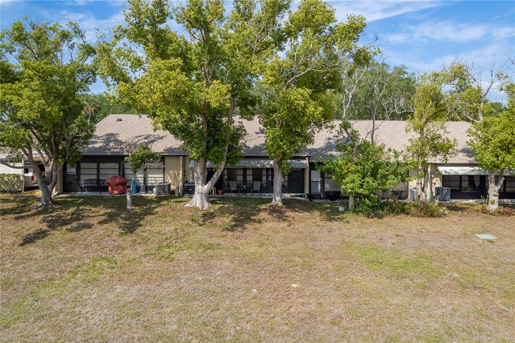 11241 Dollar Lake Drive, Unit 5 Port Richey, FL 34668 - Photo 32 of 49 a front view of a house with a yard