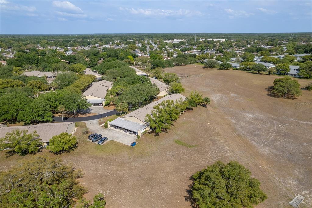11241 Dollar Lake Drive, Unit 5 Port Richey, FL 34668 - Photo 35 of 49 an aerial view of residential houses with outdoor space