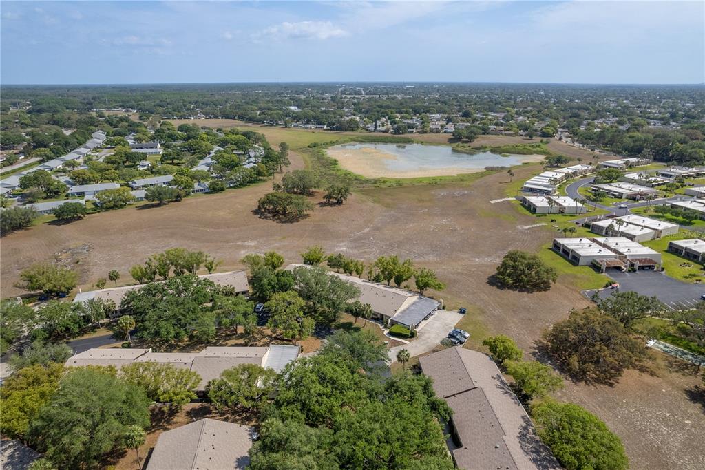 11241 Dollar Lake Drive, Unit 5 Port Richey, FL 34668 - Photo 36 of 49 an aerial view of ocean and residential houses with outdoor space