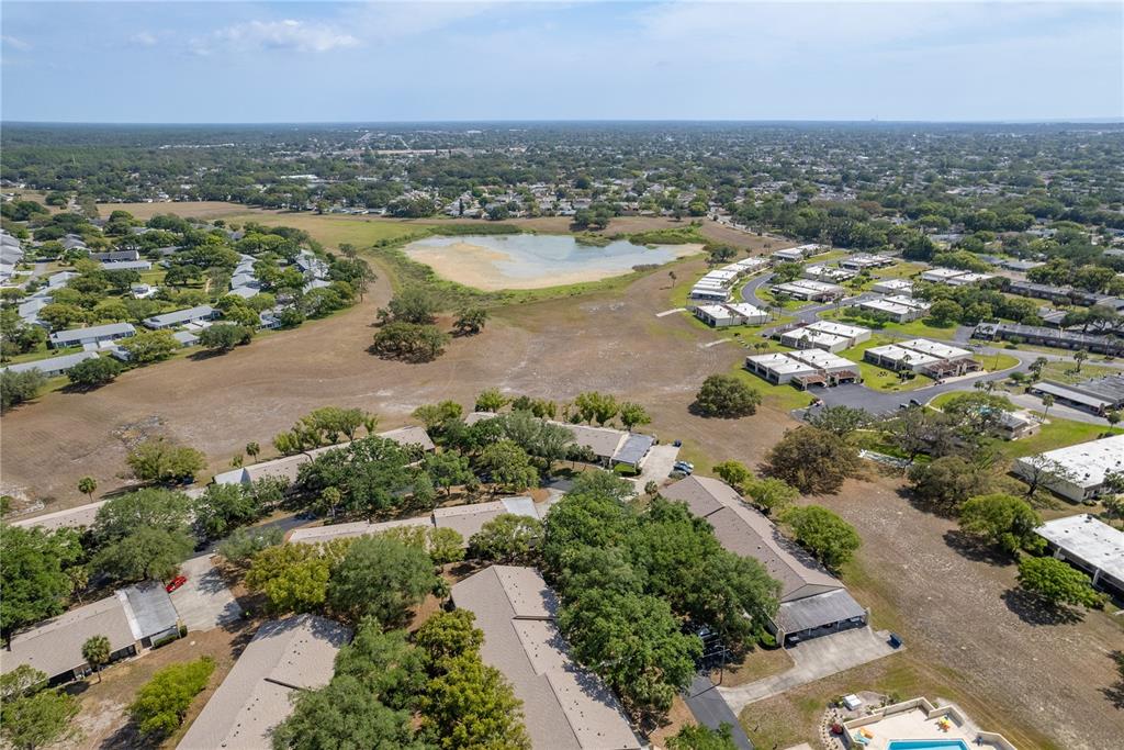 11241 Dollar Lake Drive, Unit 5 Port Richey, FL 34668 - Photo 37 of 49 an aerial view of residential building and lake