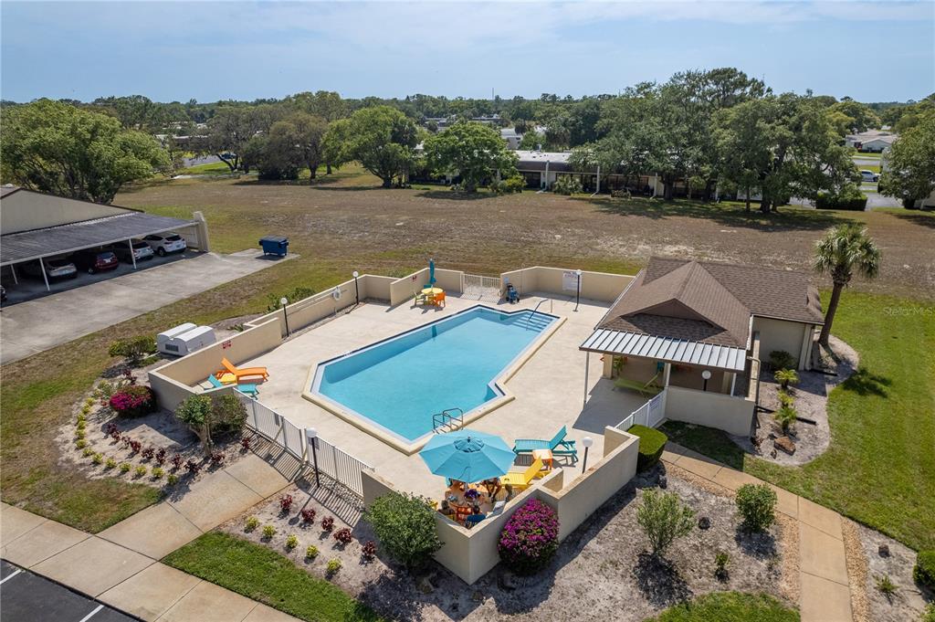 11241 Dollar Lake Drive, Unit 5 Port Richey, FL 34668 - Photo 42 of 49 an aerial view of a house with a garden and lake view