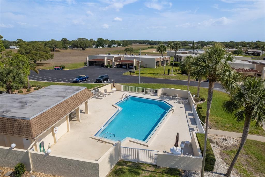 11241 Dollar Lake Drive, Unit 5 Port Richey, FL 34668 - Photo 45 of 49 an aerial view of a house with a swimming pool