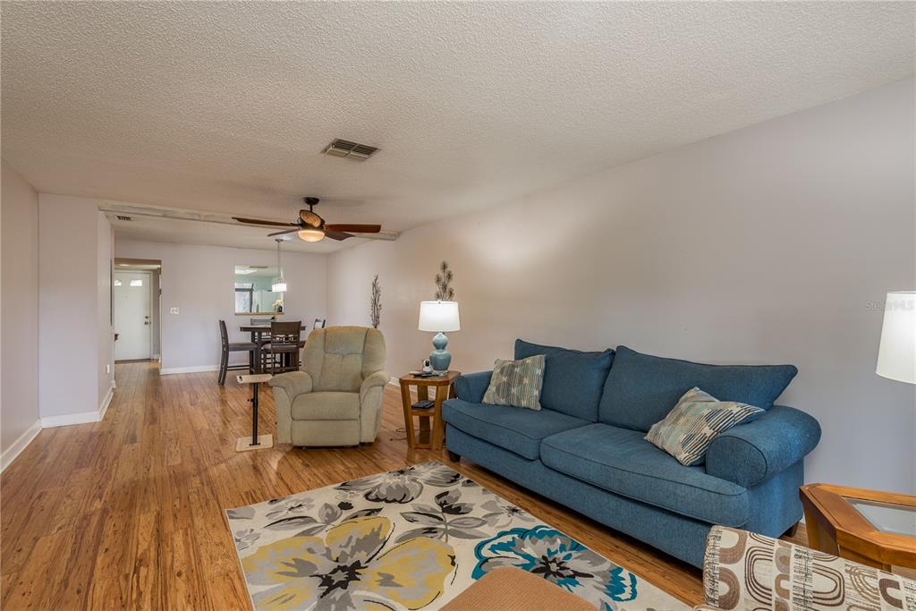 11241 Dollar Lake Drive, Unit 5 Port Richey, FL 34668 - Photo 9 of 49 a living room with furniture and a wooden floor