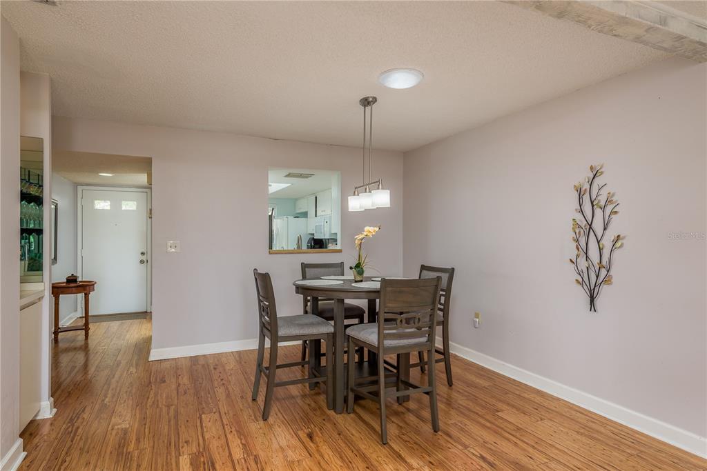 11241 Dollar Lake Drive, Unit 5 Port Richey, FL 34668 - Photo 10 of 49 a view of a dining room with furniture and wooden floor