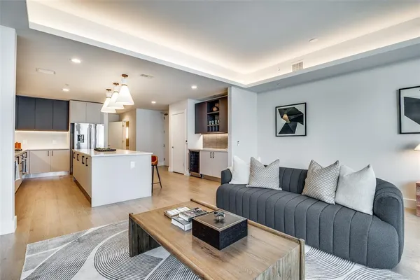 a living room with furniture and a wooden floor