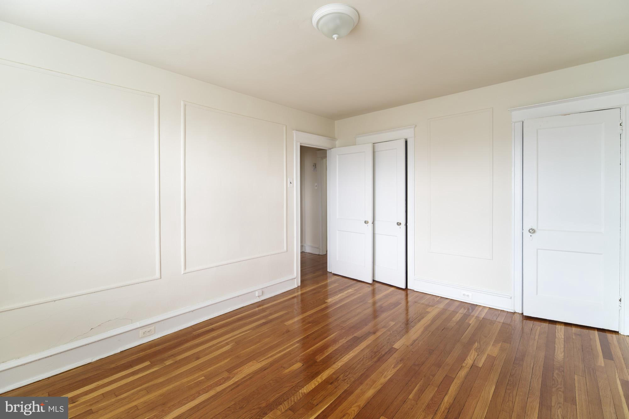 6640 Sprague Street, Unit A302 Philadelphia, PA 19119 - Photo 5 of 13 a view of an empty room with wooden floor