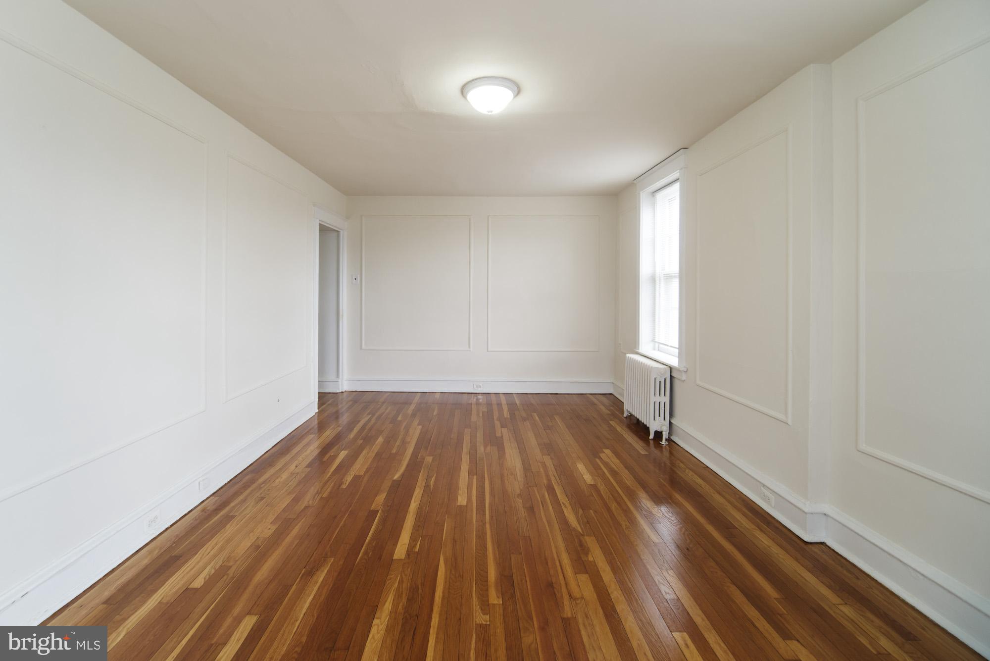 6640 Sprague Street, Unit A302 Philadelphia, PA 19119 - Photo 7 of 13 a view of wooden floor in a room