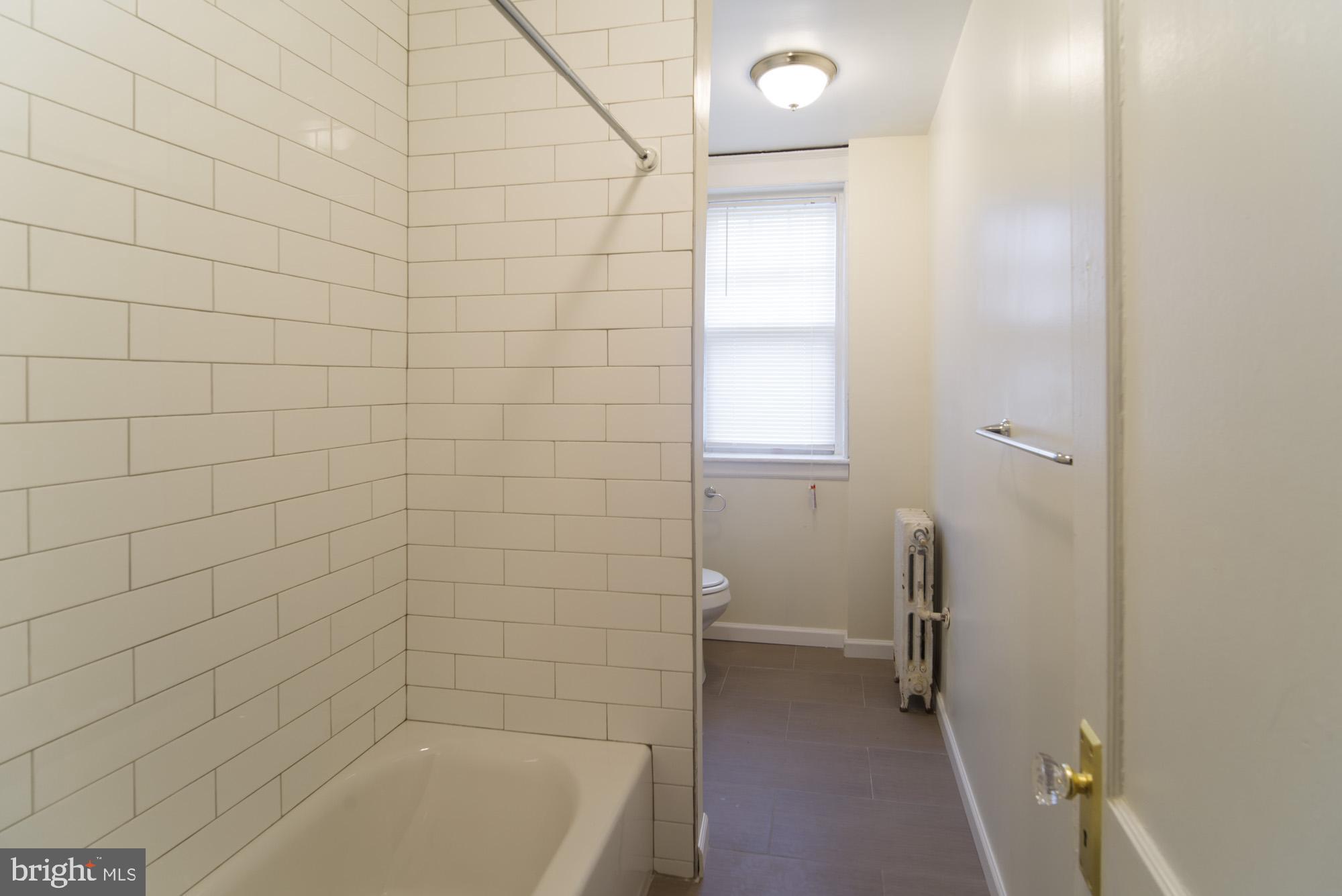 6640 Sprague Street, Unit A302 Philadelphia, PA 19119 - Photo 9 of 13 a bathroom with a bathtub