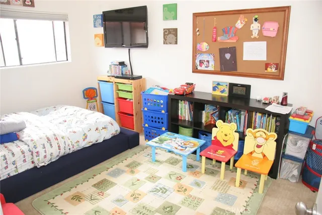 a bedroom with bed and a baby crib