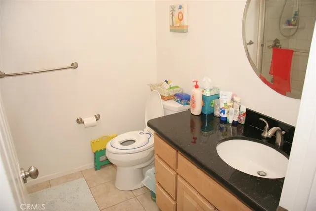 a bathroom with a sink mirror vanity and toilet