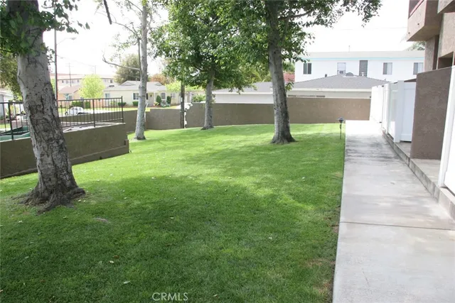 a front view of a house with a yard and tree