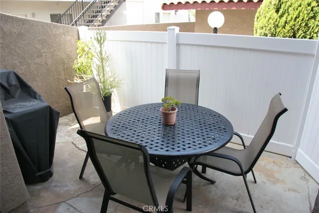 a view of a dining room with furniture and a potted plant