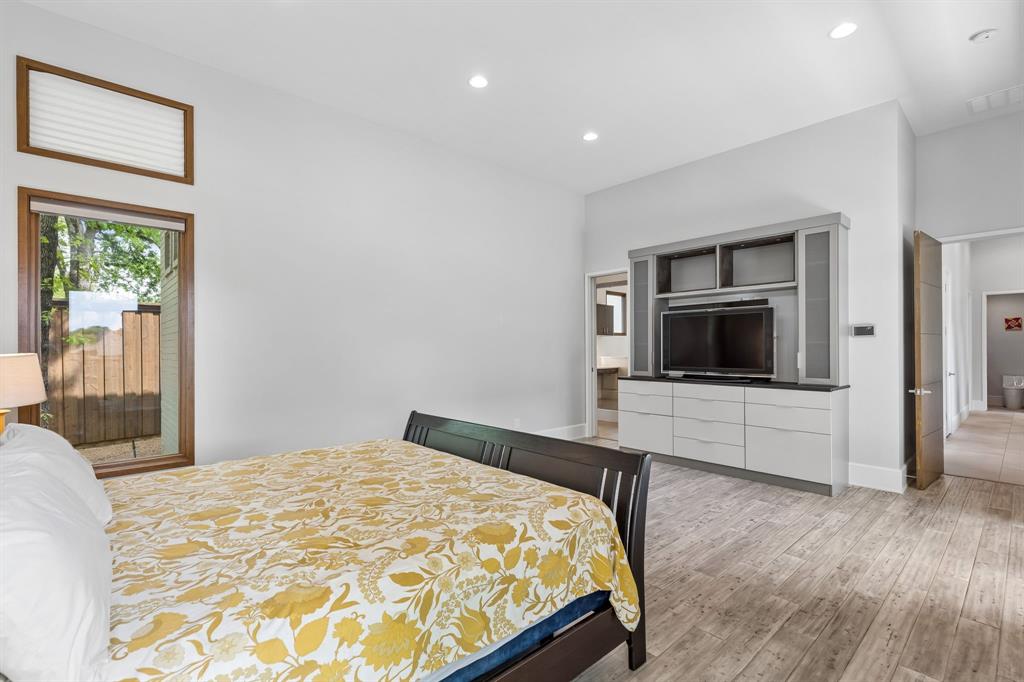 548 Oak Grove Lane Coppell, TX 75019 - Photo 19 of 36 a bedroom with a bed and a television