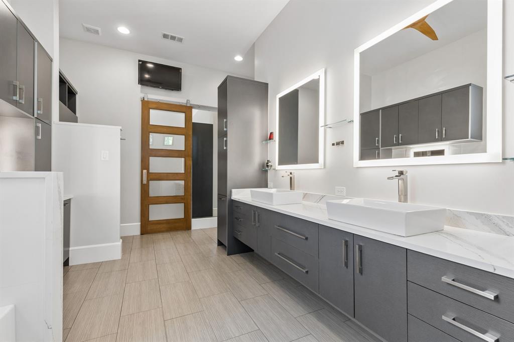 548 Oak Grove Lane Coppell, TX 75019 - Photo 21 of 36 a spacious bathroom with a double vanity sink a mirror and shower