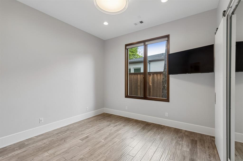548 Oak Grove Lane Coppell, TX 75019 - Photo 25 of 36 a view of an empty room with wooden floor and a window