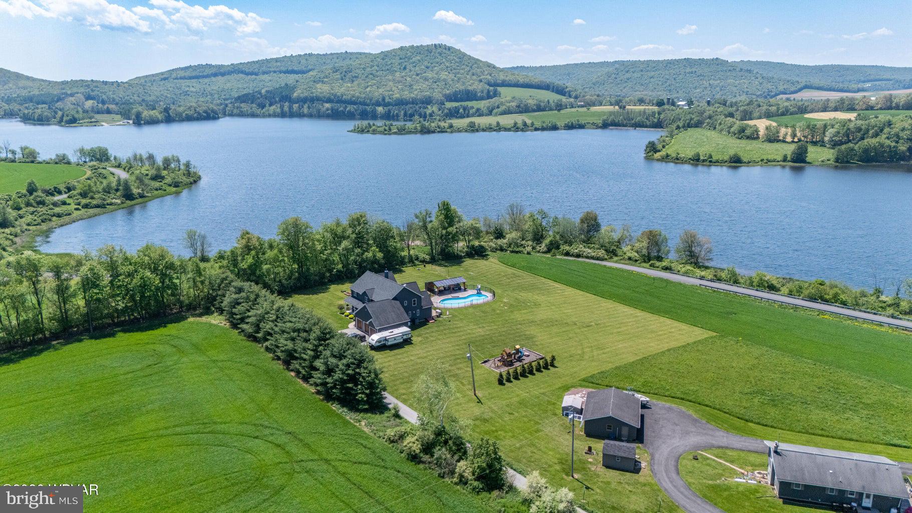 92 Easton Road Trout Run, PA 17771 - Photo 3 of 108 Serene lakeside retreat with lush fields.