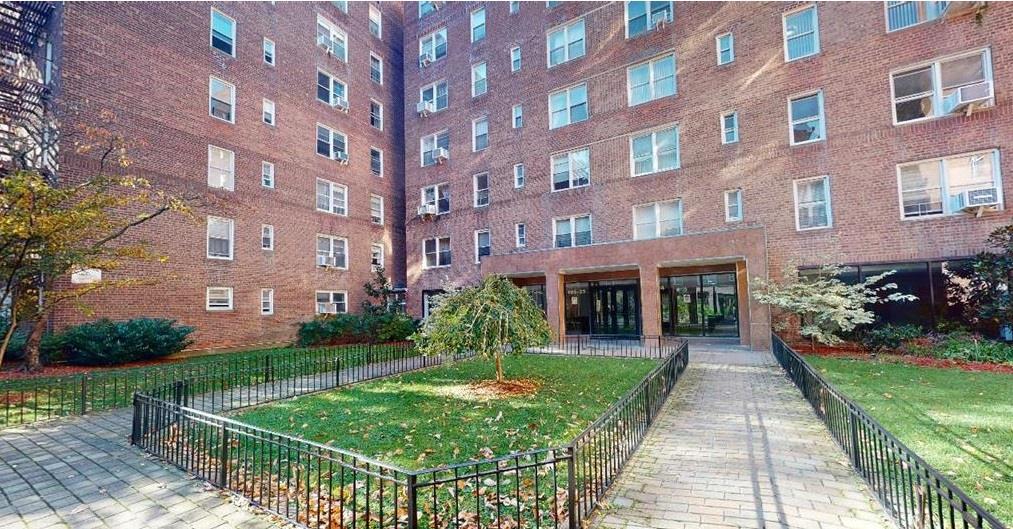 105-24 64th Road, Unit 4L Queens, NY 11375 - Photo 1 of 9 a front view of a building with garden