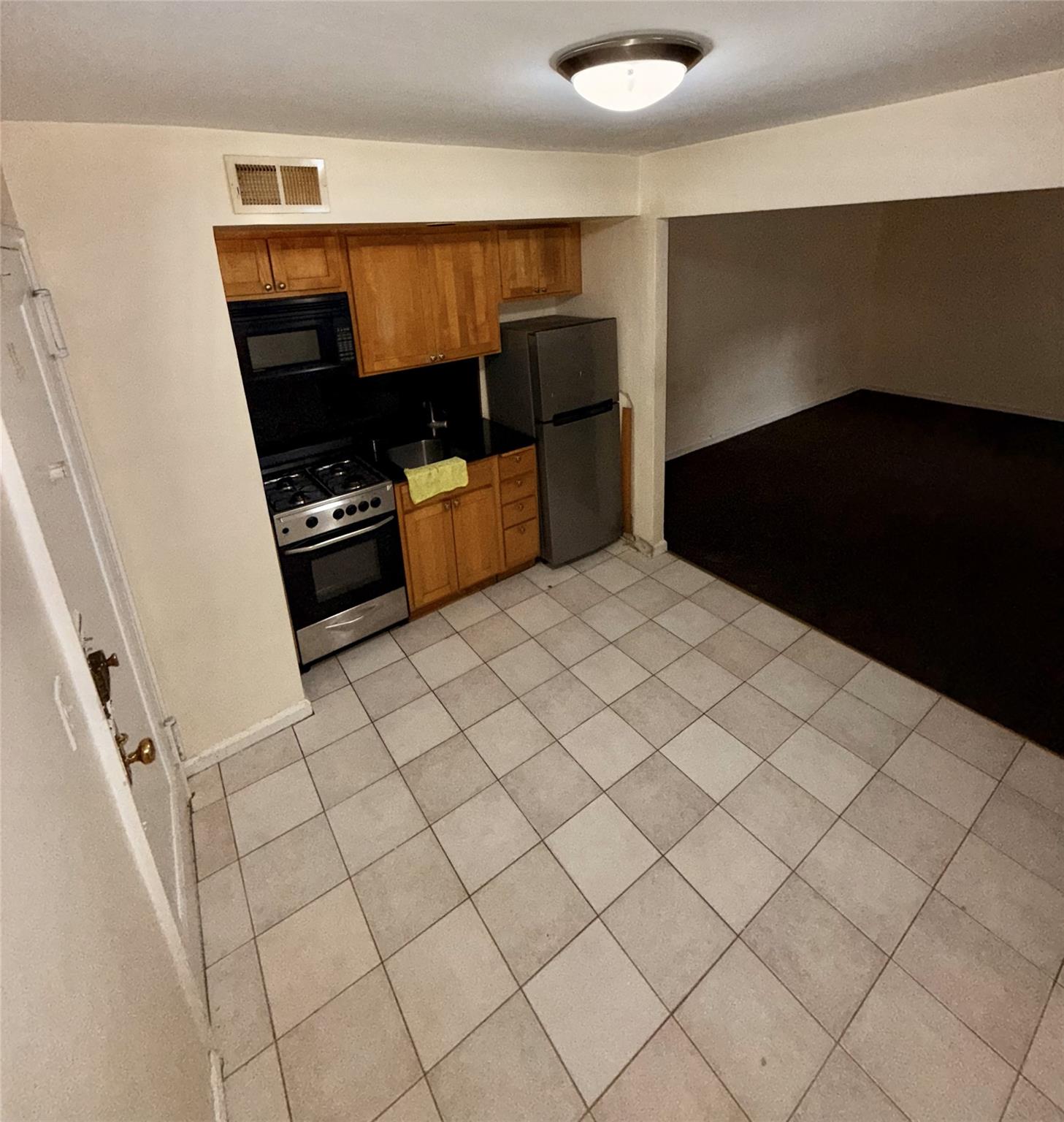 105-24 64th Road, Unit 4L Queens, NY 11375 - Photo 2 of 9 a kitchen with stainless steel appliances a refrigerator and stove