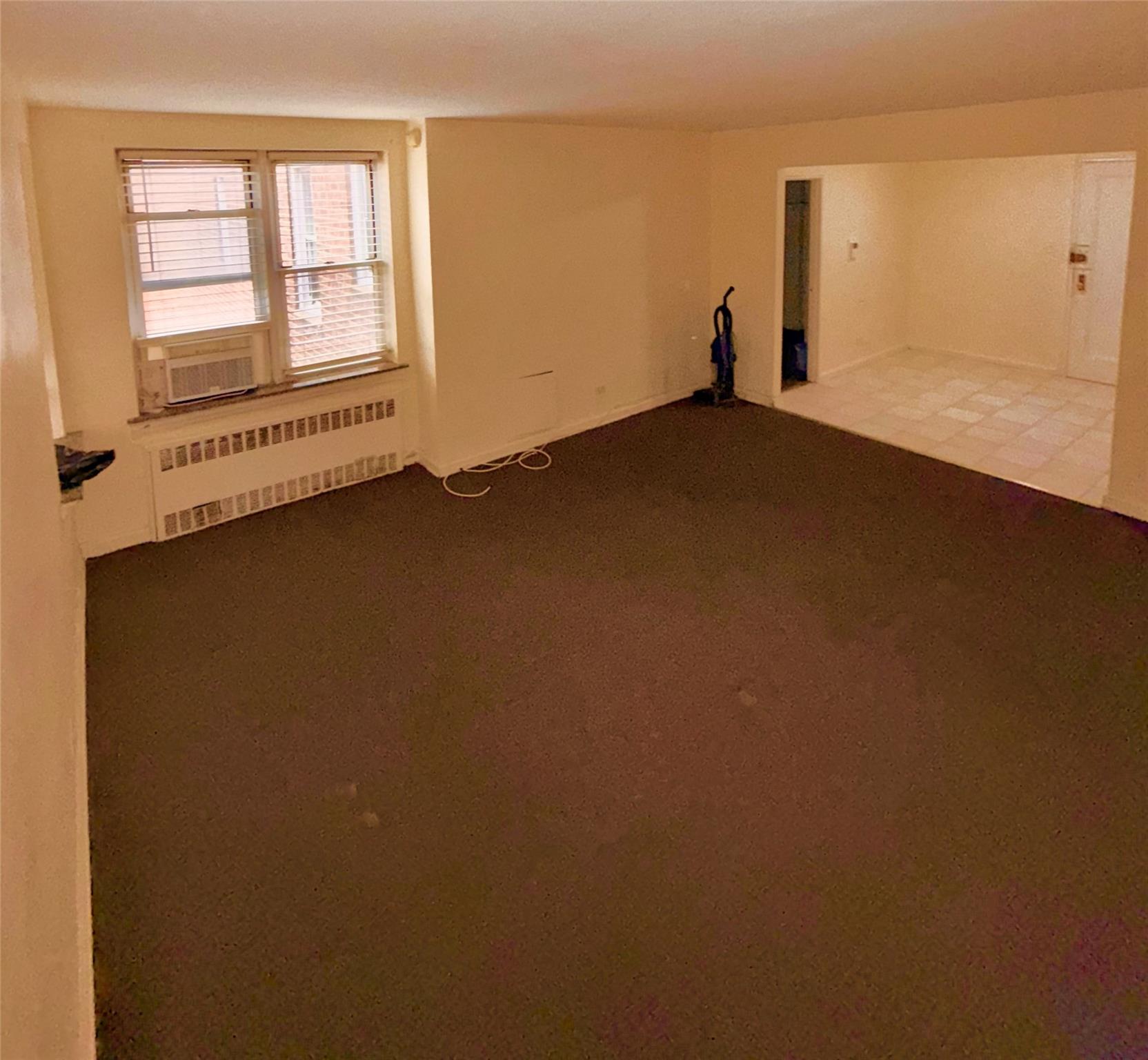 105-24 64th Road, Unit 4L Queens, NY 11375 - Photo 6 of 9 an empty room with a window
