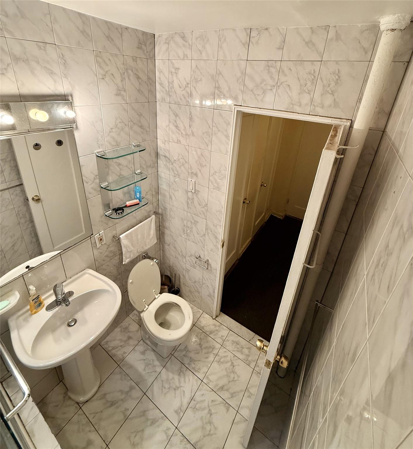 105-24 64th Road, Unit 4L Queens, NY 11375 - Photo 8 of 9 a bathroom with a sink toilet and shower