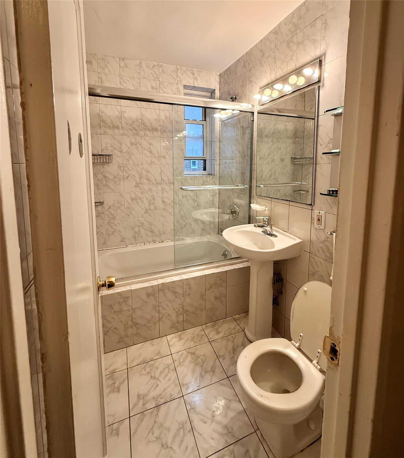 105-24 64th Road, Unit 4L Queens, NY 11375 - Photo 9 of 9 a bathroom with a sink toilet and shower