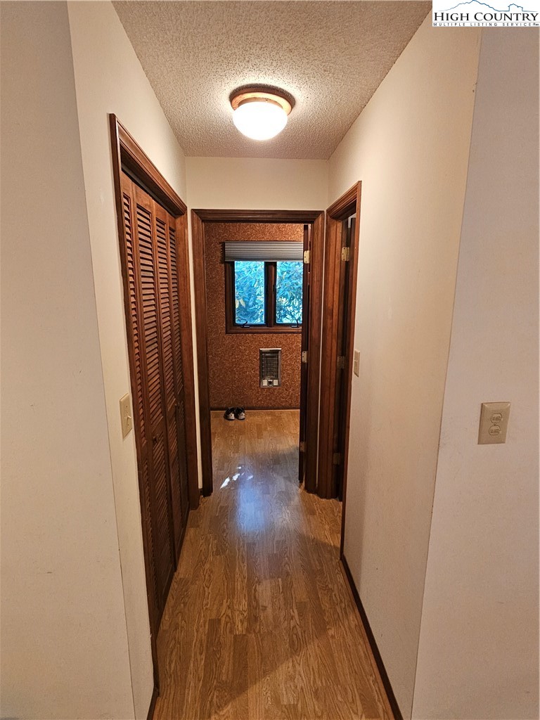 109 Foxgrape Hollow Road Beech Mountain, NC 28604 - Photo 11 of 50 a view of a hallway and wooden floor with windows