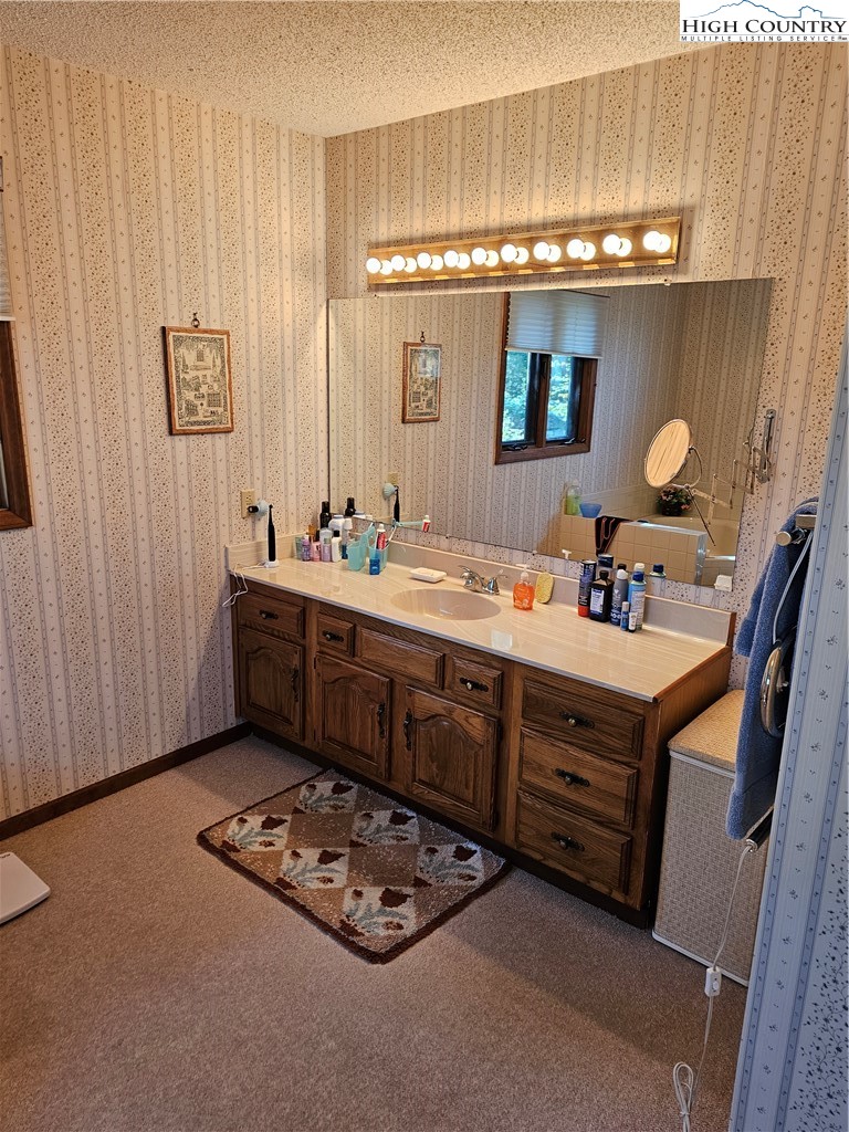 109 Foxgrape Hollow Road Beech Mountain, NC 28604 - Photo 17 of 50 a bathroom with a sink double vanity and a mirror