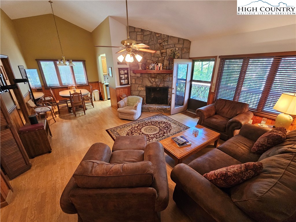 109 Foxgrape Hollow Road Beech Mountain, NC 28604 - Photo 3 of 50 a living room with furniture a fireplace and a chandelier