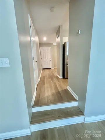 a view of an empty room with a fireplace and a window