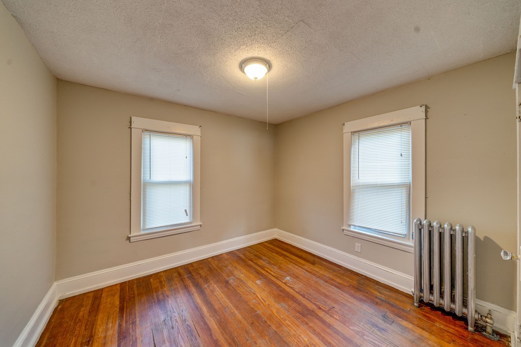 247-249 Commonwealth Avenue Springfield, MA 01108 - Photo 11 of 26 an empty room with wooden floor and windows