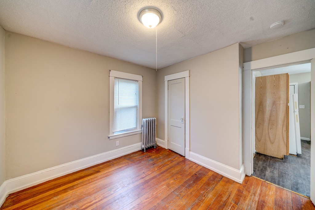 247-249 Commonwealth Avenue Springfield, MA 01108 - Photo 12 of 26 an empty room with wooden floor and windows
