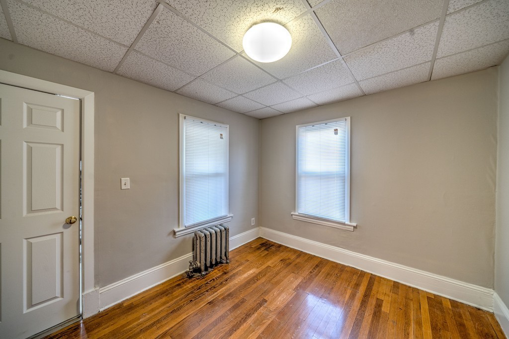 247-249 Commonwealth Avenue Springfield, MA 01108 - Photo 16 of 26 a view of an empty room with wooden floor and a window