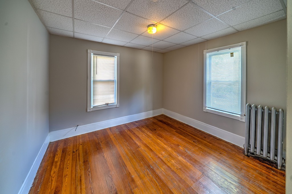 247-249 Commonwealth Avenue Springfield, MA 01108 - Photo 19 of 26 a view of empty room with wooden floor and fan