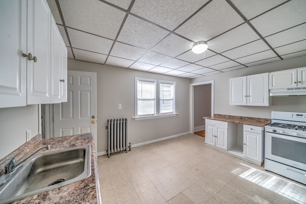 247-249 Commonwealth Avenue Springfield, MA 01108 - Photo 23 of 26 a kitchen with stainless steel appliances granite countertop a sink stove and cabinets