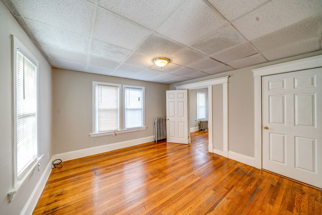 247-249 Commonwealth Avenue Springfield, MA 01108 - Photo 25 of 26 a view of an empty room with wooden floor and a window